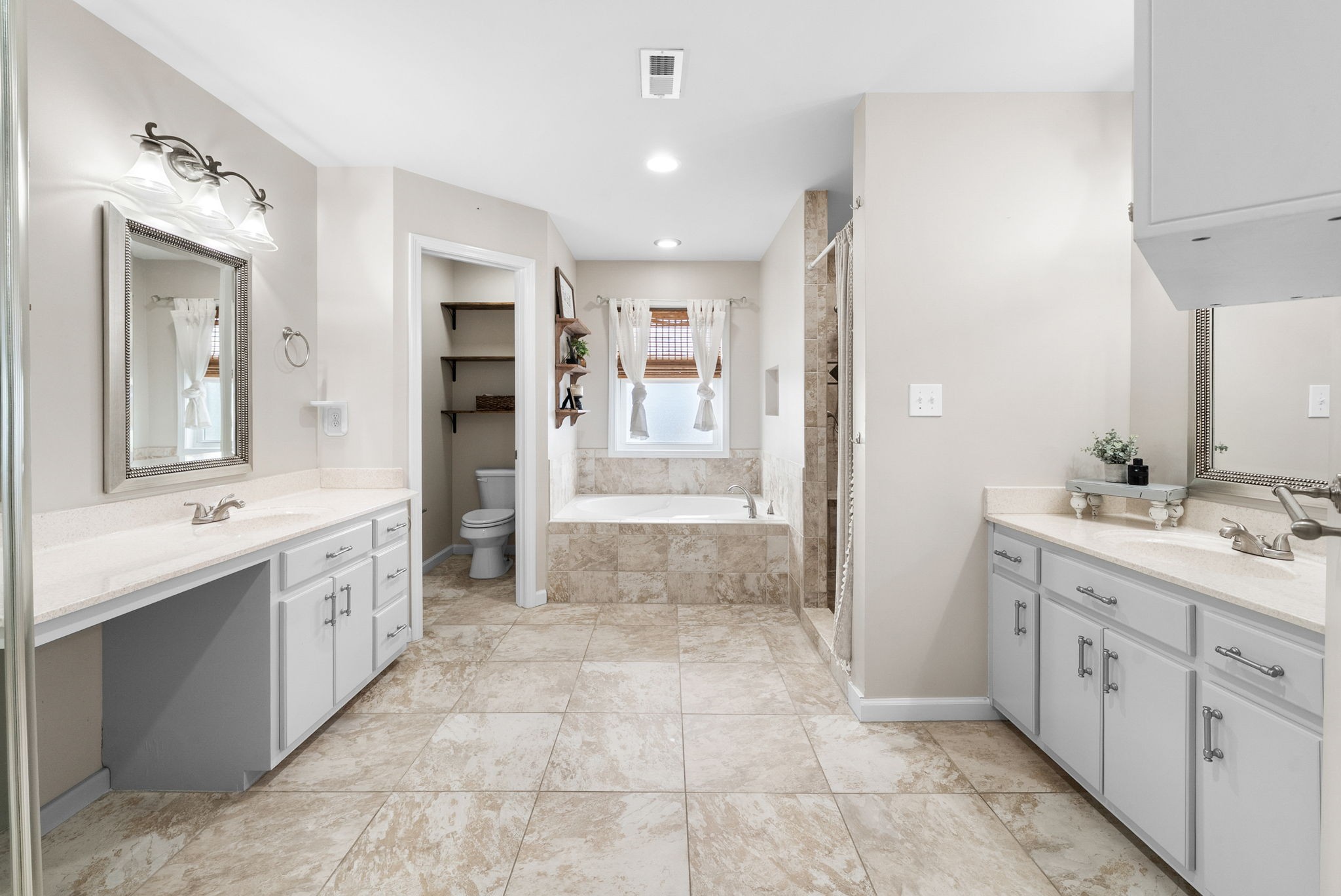 3021 7 Mile Ferry Road Clarksville, TN 37040 - Photo 37 of 99 a bathroom with a double vanity sink a large mirror and a shower