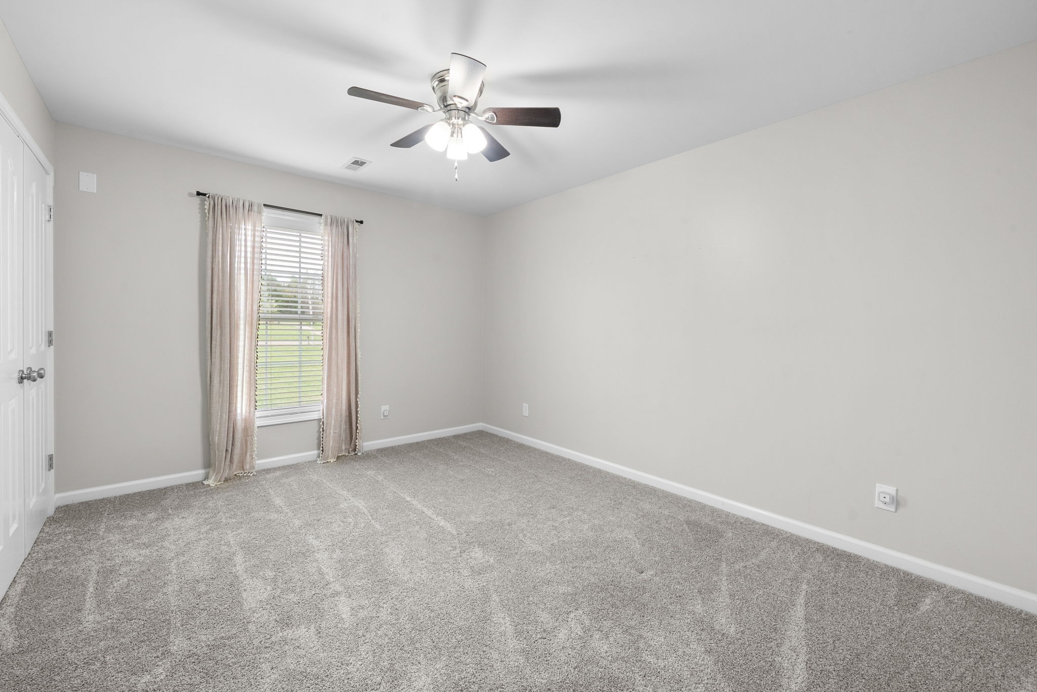 3021 7 Mile Ferry Road Clarksville, TN 37040 - Photo 49 of 99 an empty room with a chandelier fan and windows