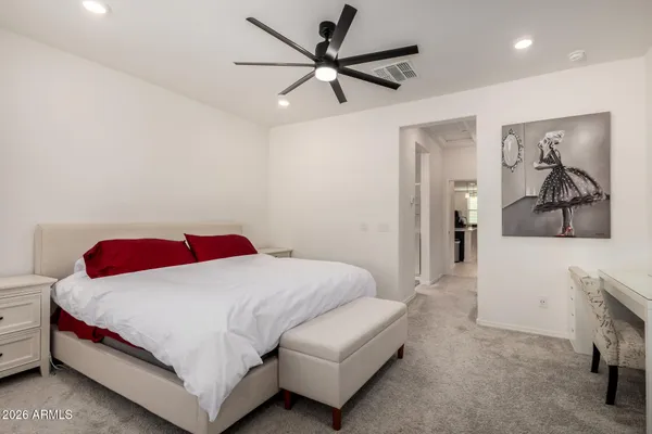 a bedroom with a bed and a chandelier
