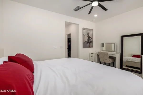 a bedroom with a large bed and a chandelier