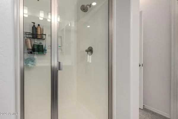 a bathroom with a glass shower door
