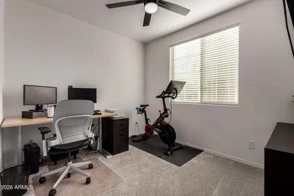 a view of a workspace with furniture and a window