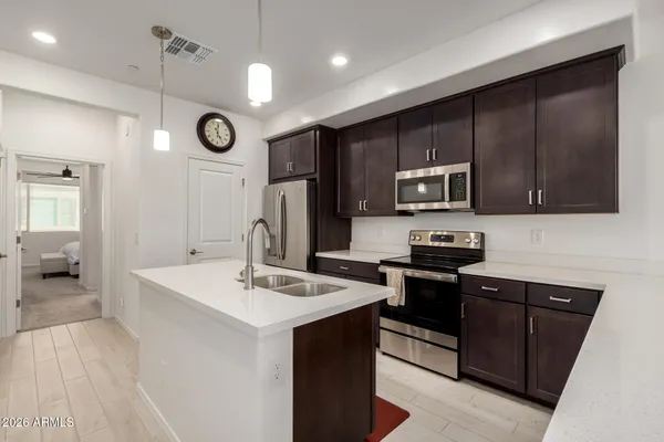 a kitchen with a sink a microwave a stove and refrigerator