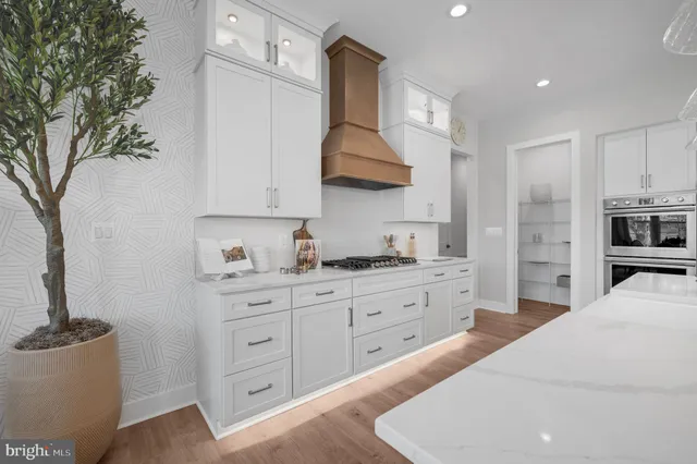 a kitchen with granite countertop a sink stainless steel appliances and cabinets