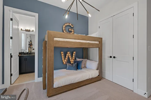 a bedroom with a bed and a chandelier