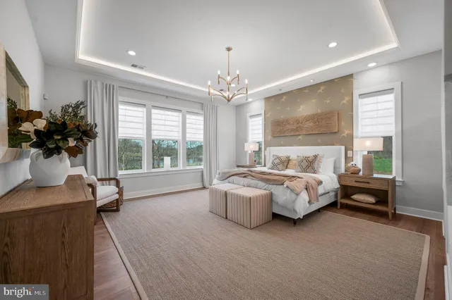 a bedroom with bed and a large window