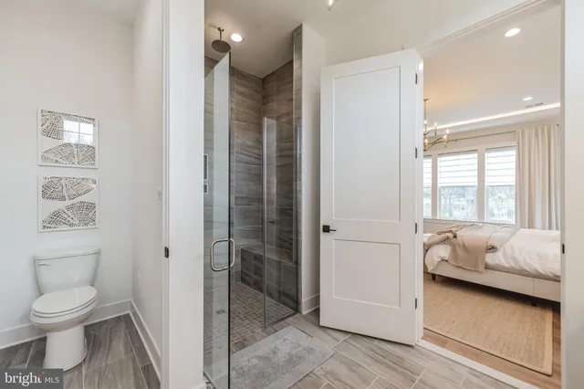 a bathroom with a tub shower and toilet