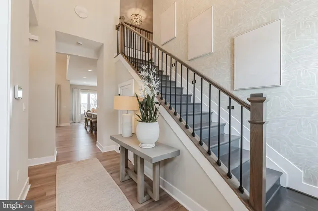 a view of entryway and hall with wooden floor