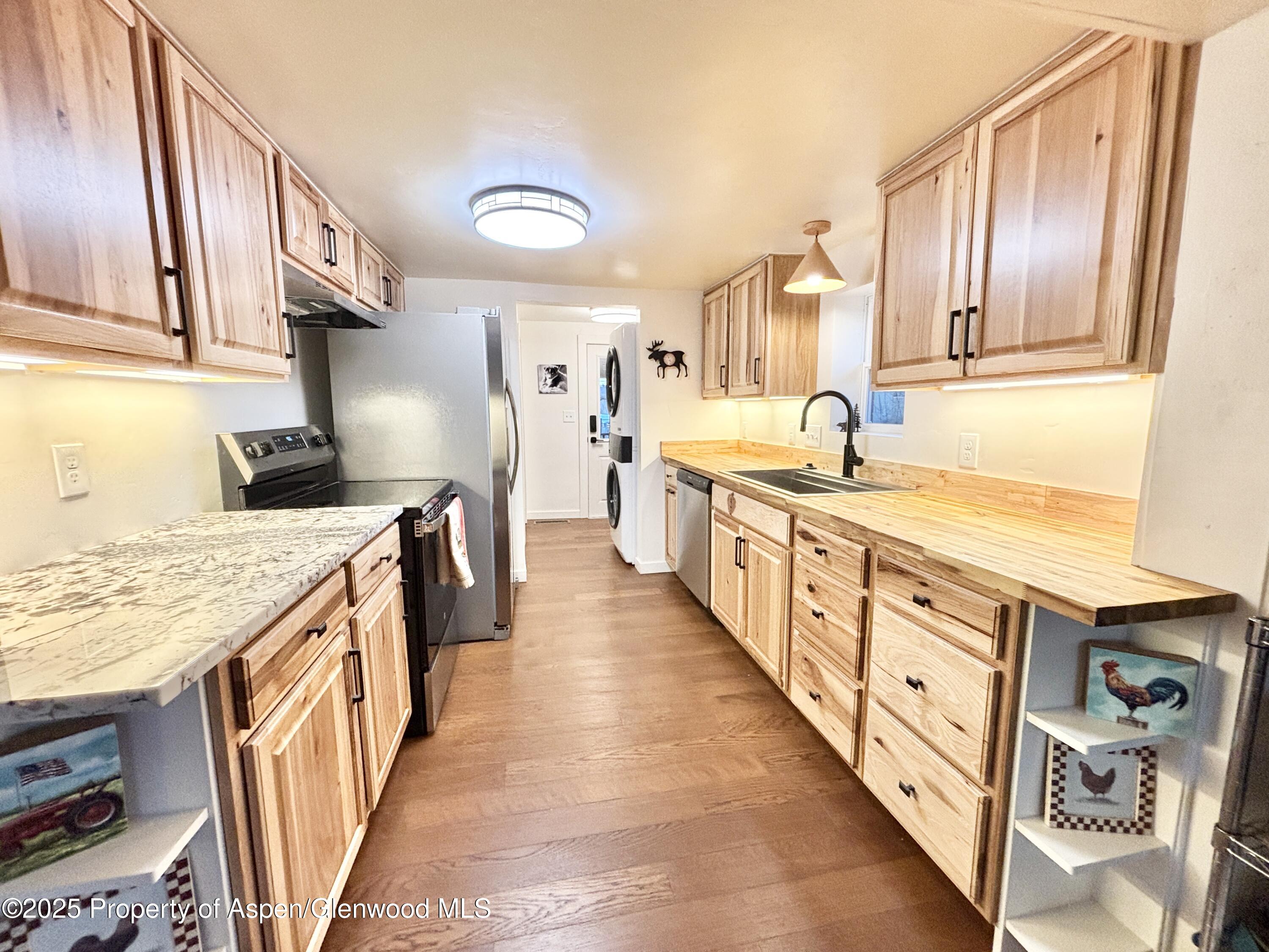 a kitchen with stainless steel appliances granite countertop a stove and a sink