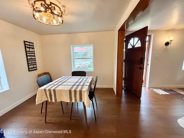 a view of a dining room with furniture and wooden floor