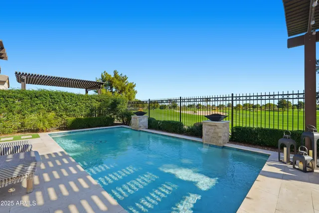 a swimming pool with outdoor seating and garden