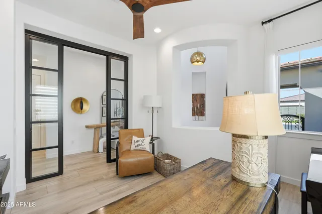 a bedroom with a bed a mirror and furniture