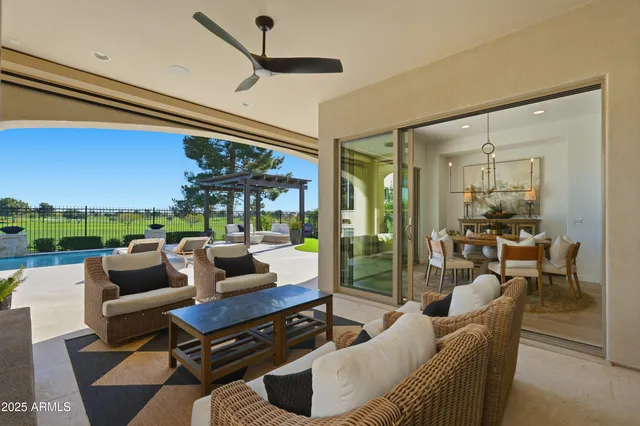 a view of a swimming pool with a chair and palm trees