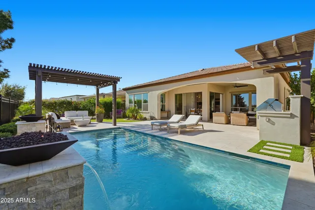 a view of a house with a yard and potted plants