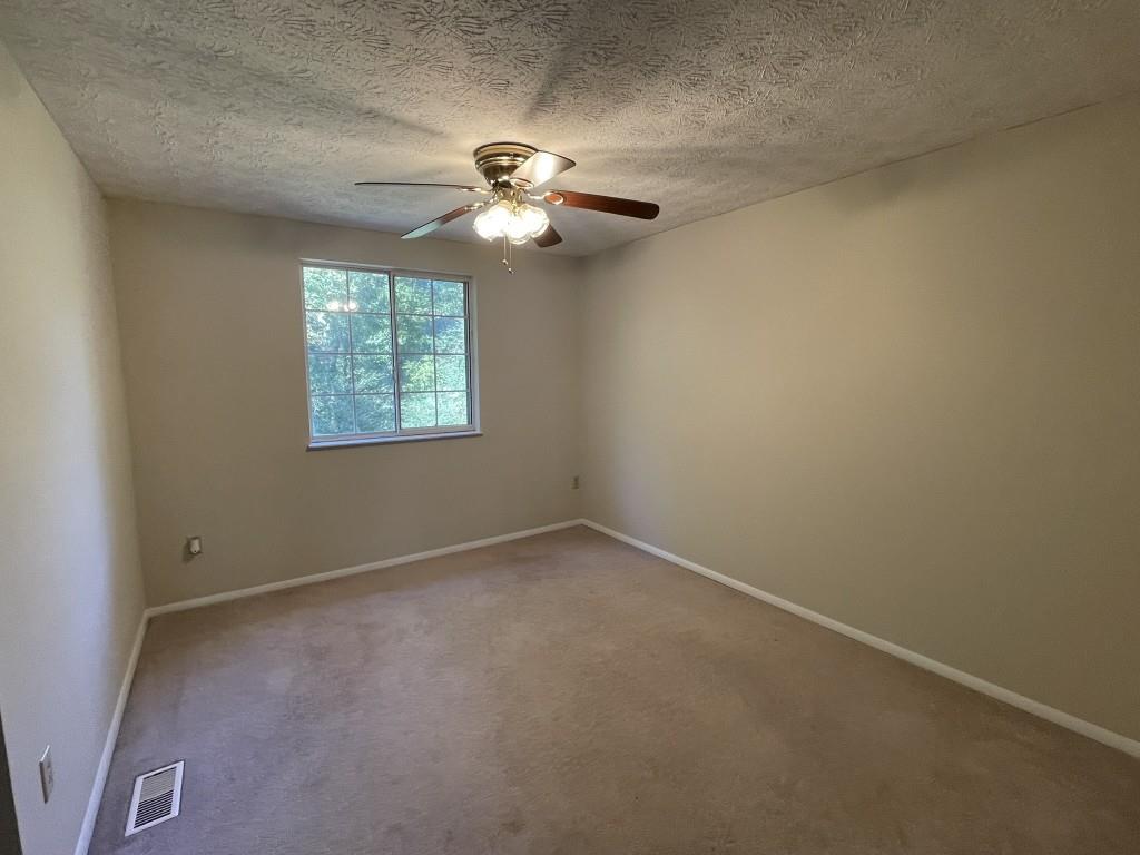 110 Roswell Commons Way Roswell, GA 30076 - Photo 11 of 26 an empty room with windows and fan