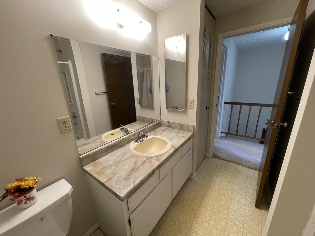 110 Roswell Commons Way Roswell, GA 30076 - Photo 16 of 26 a bathroom with a granite countertop sink and a mirror