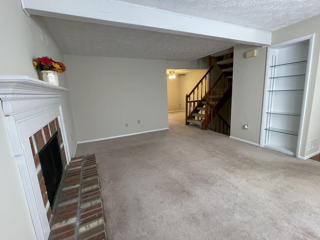 110 Roswell Commons Way Roswell, GA 30076 - Photo 3 of 26 a view of an empty room with stairs and toys