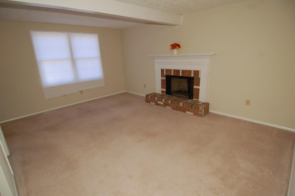 110 Roswell Commons Way Roswell, GA 30076 - Photo 5 of 26 an empty room with a fireplace and window