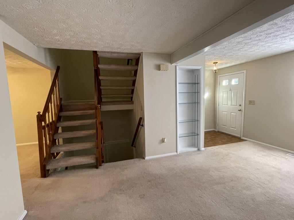 110 Roswell Commons Way Roswell, GA 30076 - Photo 7 of 26 a view of an empty room with a fireplace and a window