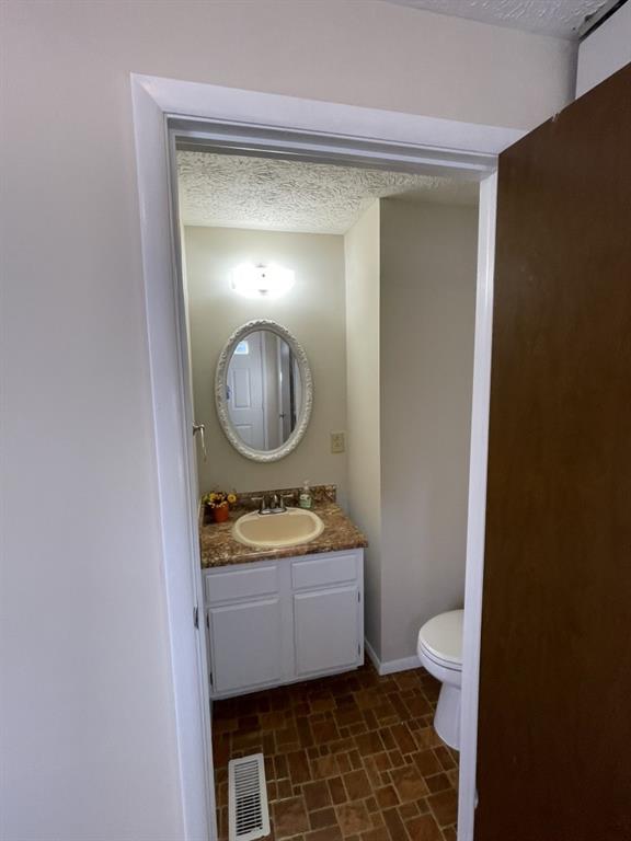110 Roswell Commons Way Roswell, GA 30076 - Photo 9 of 26 a bathroom with a toilet mirror vanity and a sink