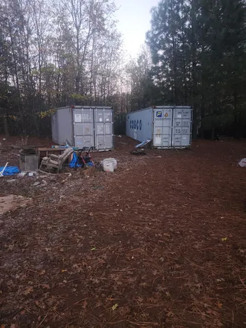 a backyard of a house with barbeque oven and a stove