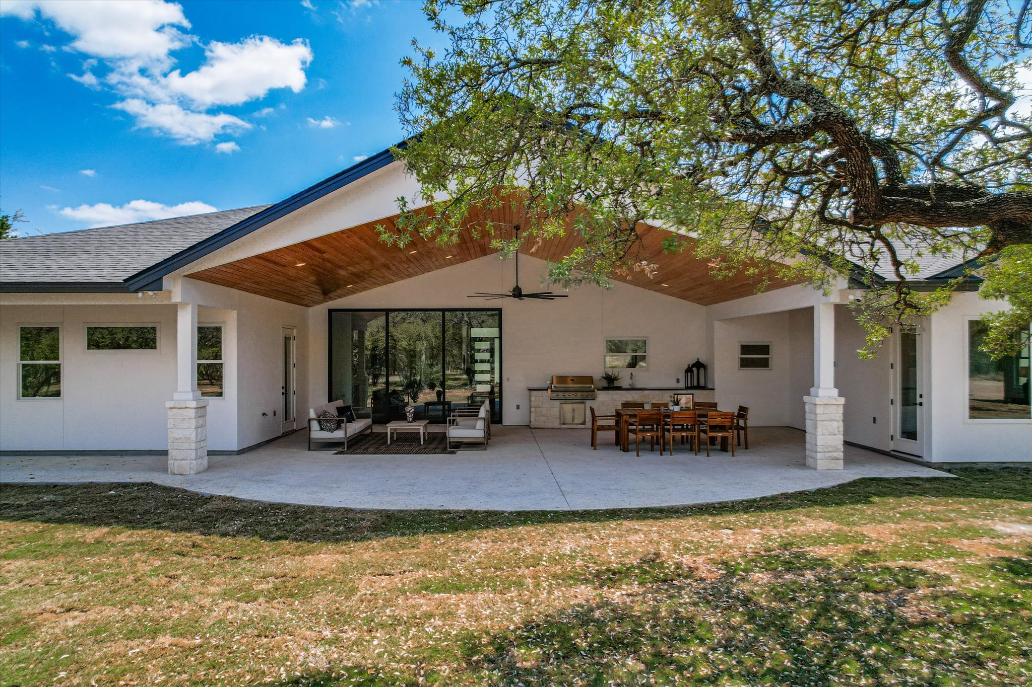 410 Shady Tree Drive Georgetown, TX 78633 - Photo 28 of 40 Rear view of property with a lawn, a patio area, stucco siding, and an outdoor living / dining area