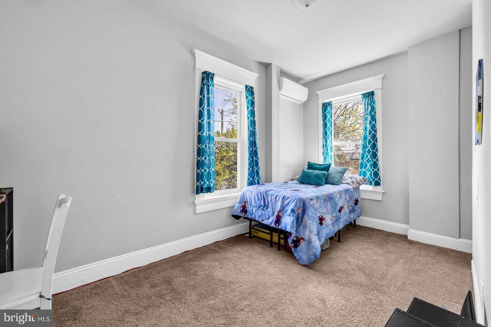 406 High Street Cambridge, MD 21613 - Photo 13 of 24 a bed sitting in a room next to a window