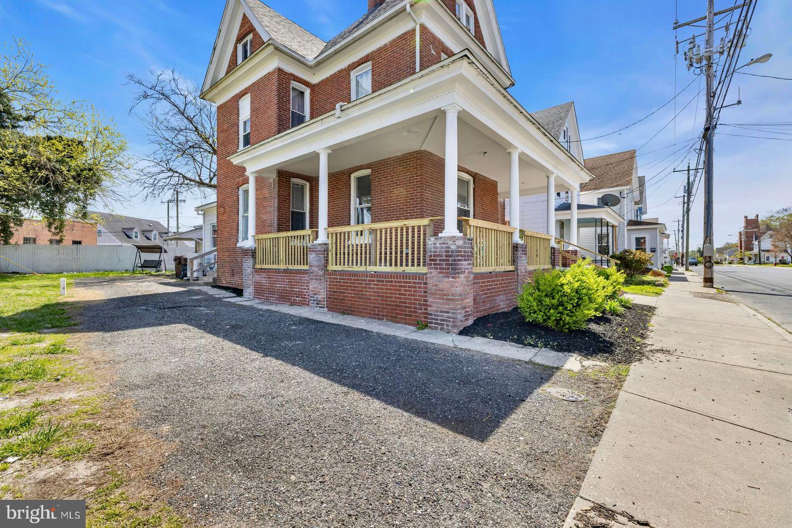 406 High Street Cambridge, MD 21613 - Photo 18 of 24 a front view of a house with garden
