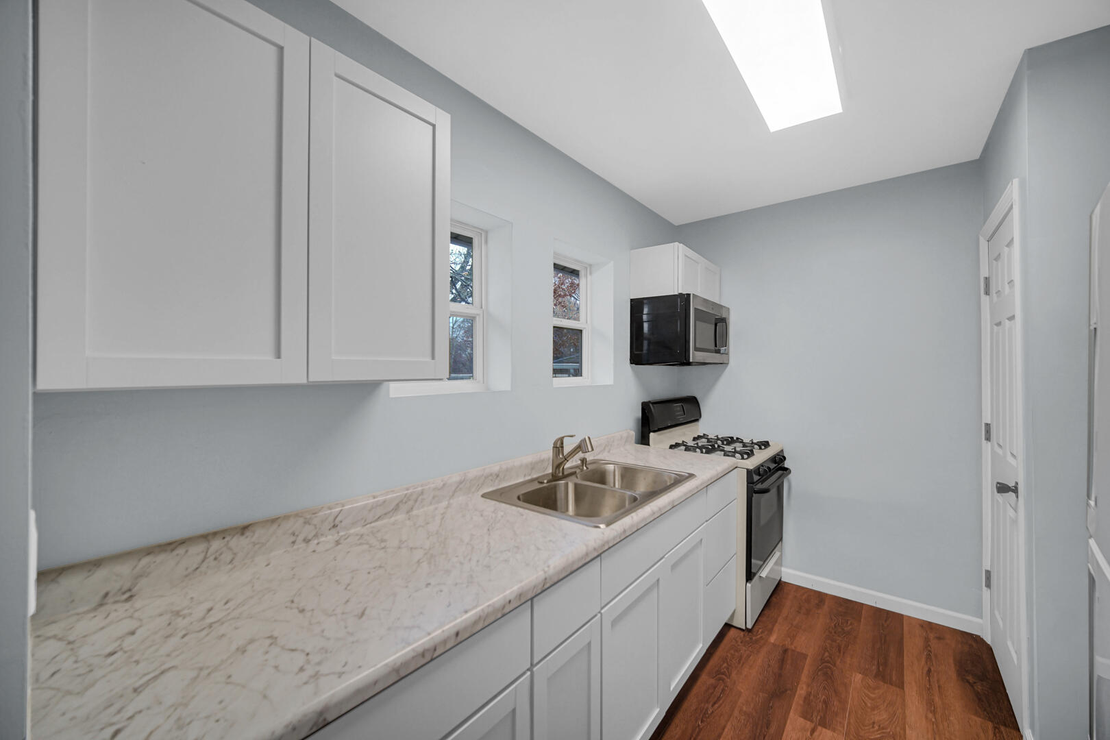 523 West 3rd Street Hobart, IN 46342 - Photo 11 of 17 a kitchen with stainless steel appliances granite countertop a sink stove and microwave