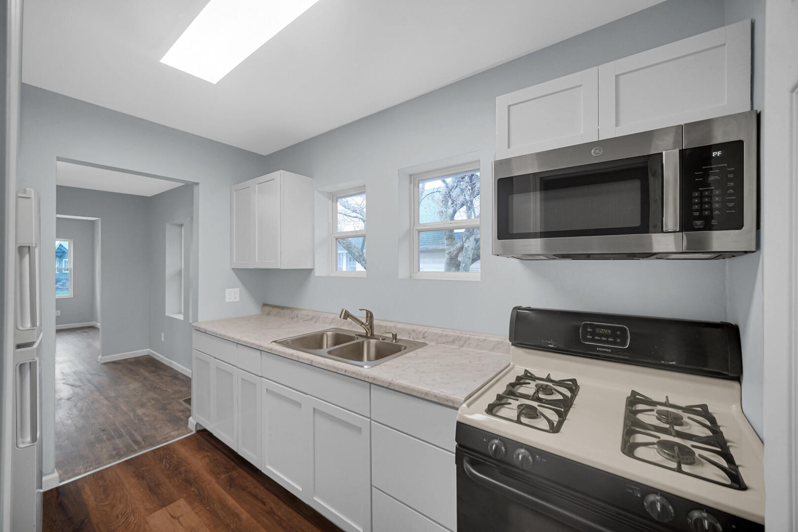 523 West 3rd Street Hobart, IN 46342 - Photo 13 of 17 a kitchen with stainless steel appliances a stove microwave and sink