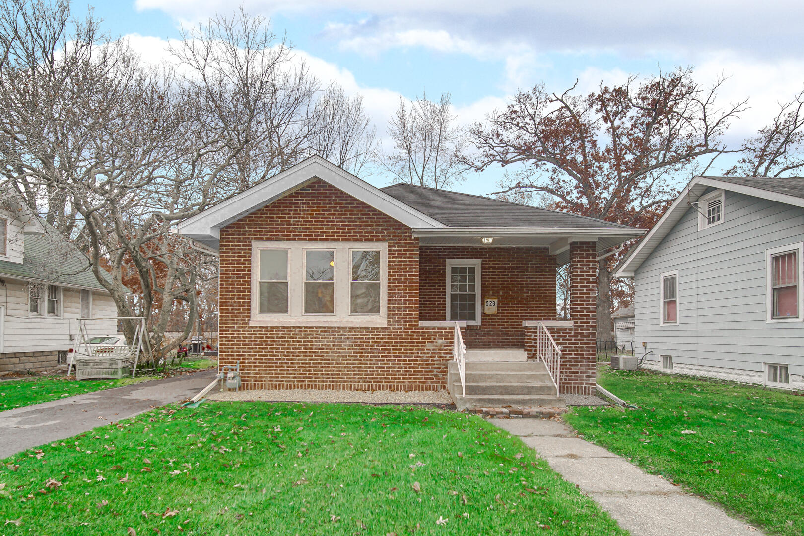 523 West 3rd Street Hobart, IN 46342 - Photo 2 of 17 a front view of a house with a garden
