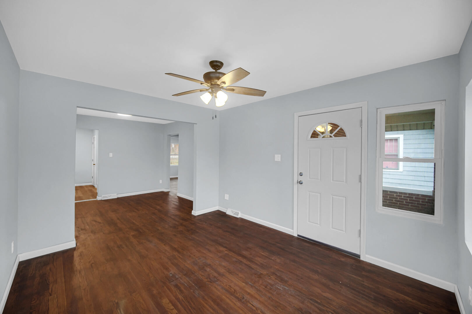 523 West 3rd Street Hobart, IN 46342 - Photo 4 of 17 wooden floor in an empty room with a window