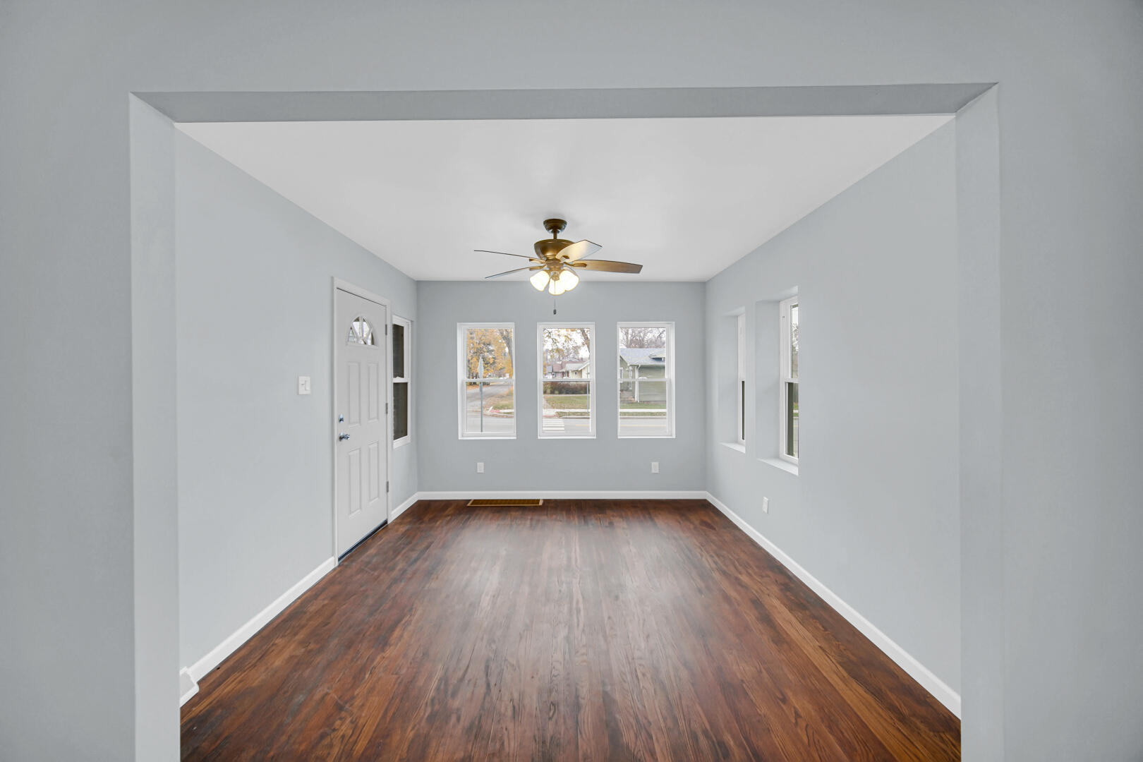 523 West 3rd Street Hobart, IN 46342 - Photo 6 of 17 a view of an empty room with wooden floor and a window