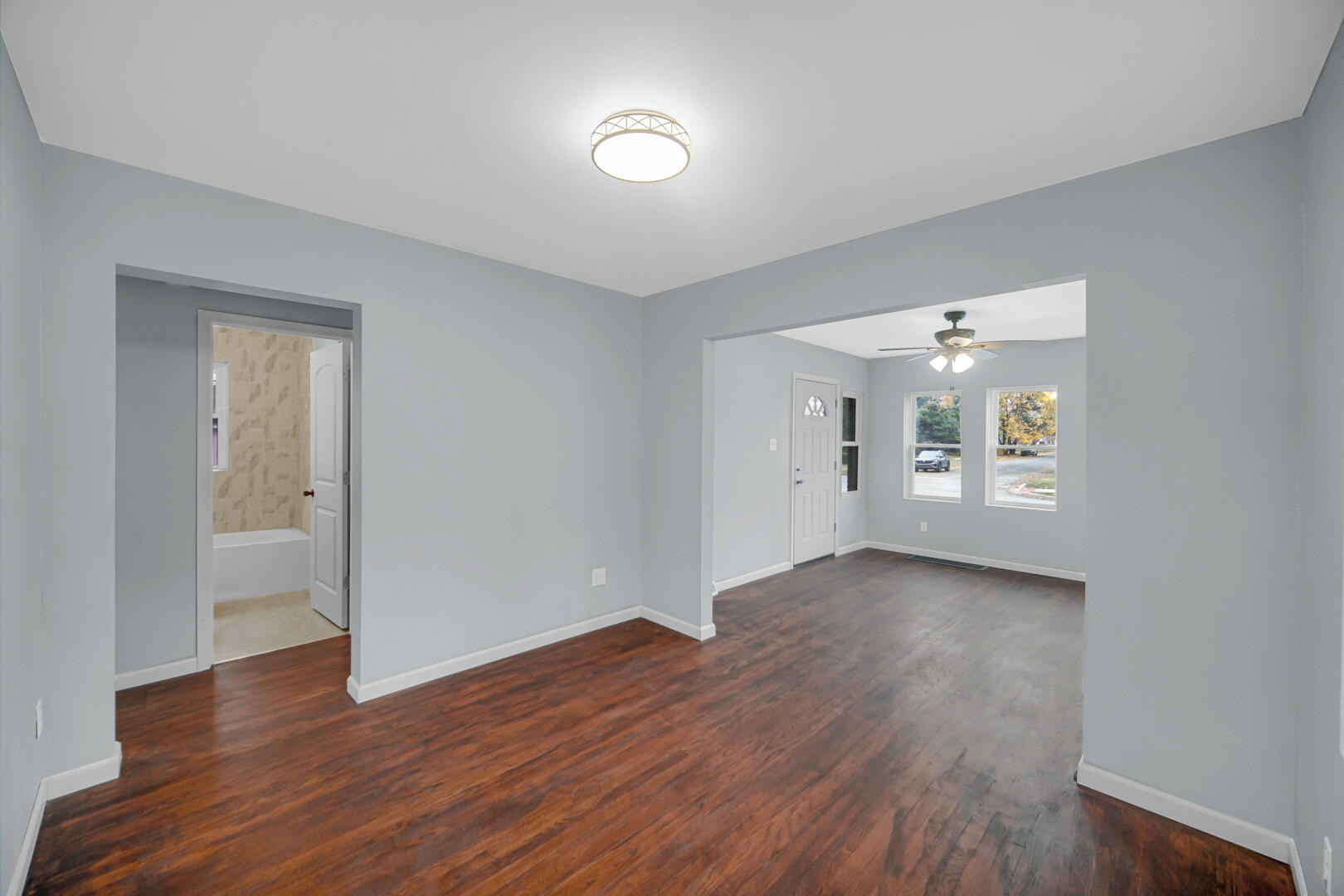 523 West 3rd Street Hobart, IN 46342 - Photo 7 of 17 an empty room with wooden floor and windows