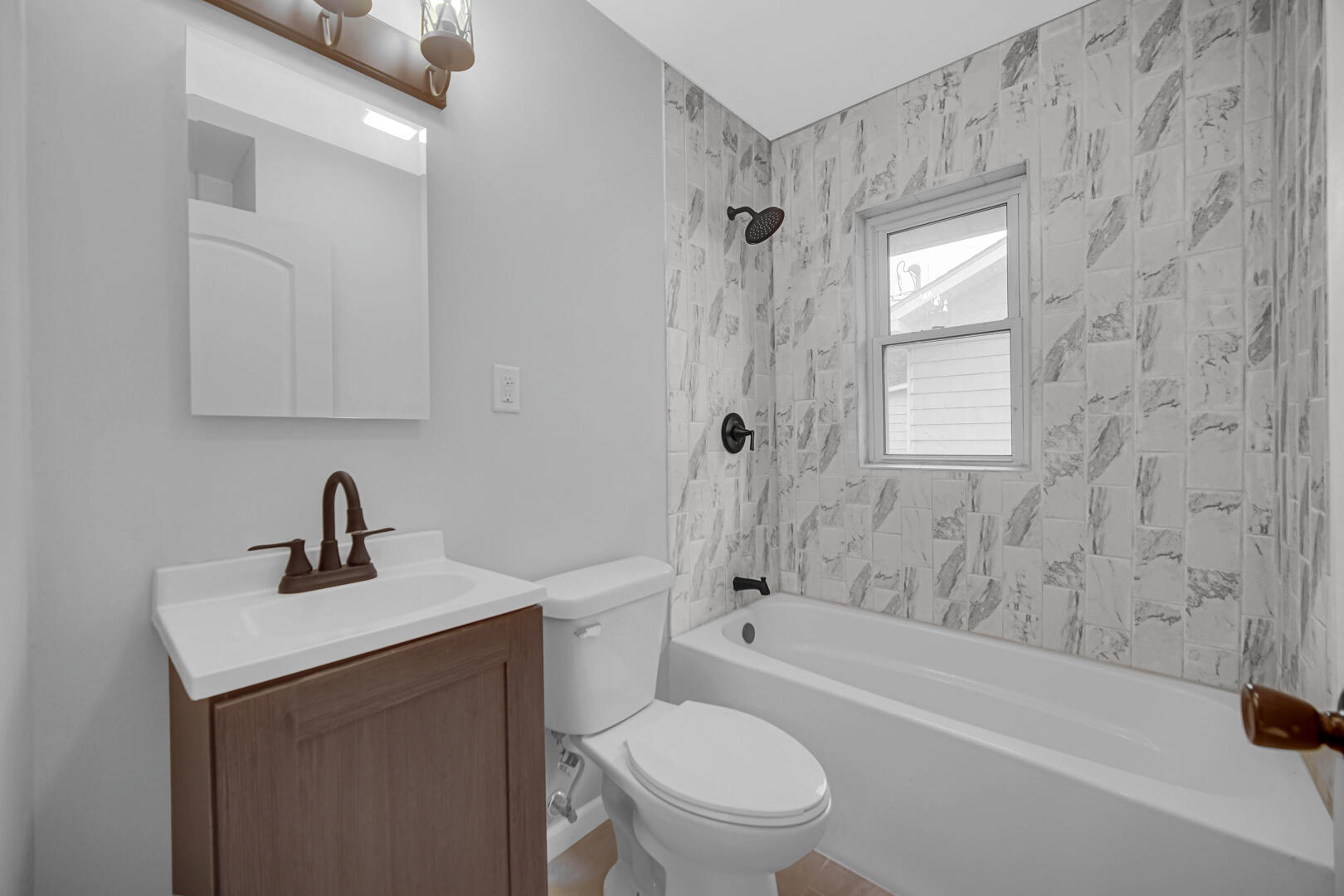 523 West 3rd Street Hobart, IN 46342 - Photo 8 of 17 a bathroom with a sink a toilet and shower
