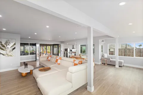 a kitchen with stainless steel appliances granite countertop a sink a stove and a wooden floors