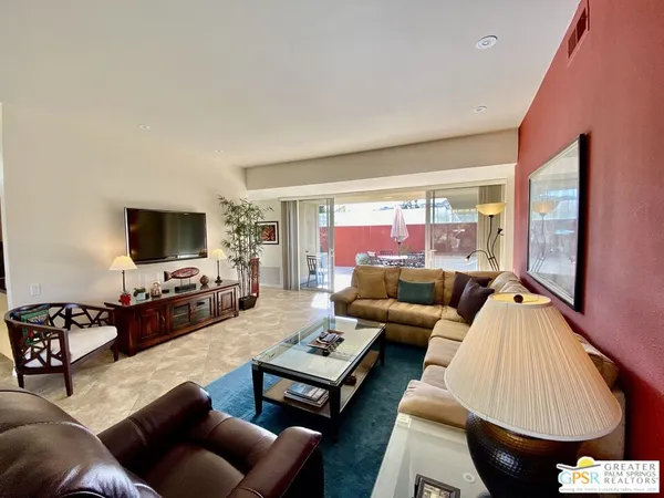 a bedroom with a bed and a tv on dresser