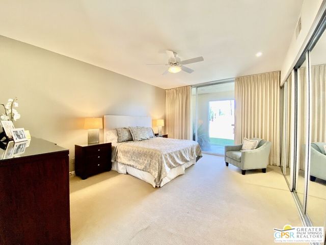 a spacious bedroom with a bed and dresser