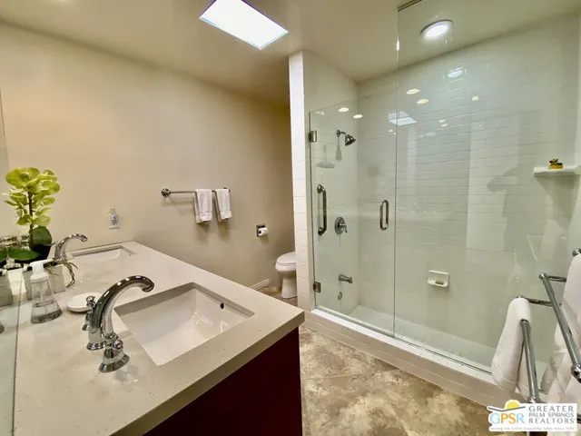 a bathroom with a tub sink and mirror