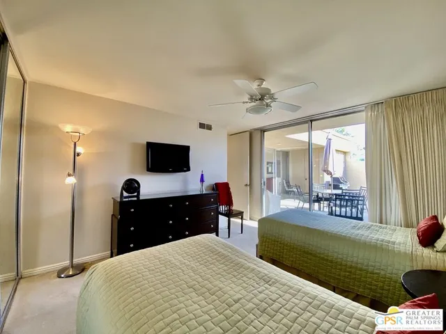 a bedroom with a bed and a television