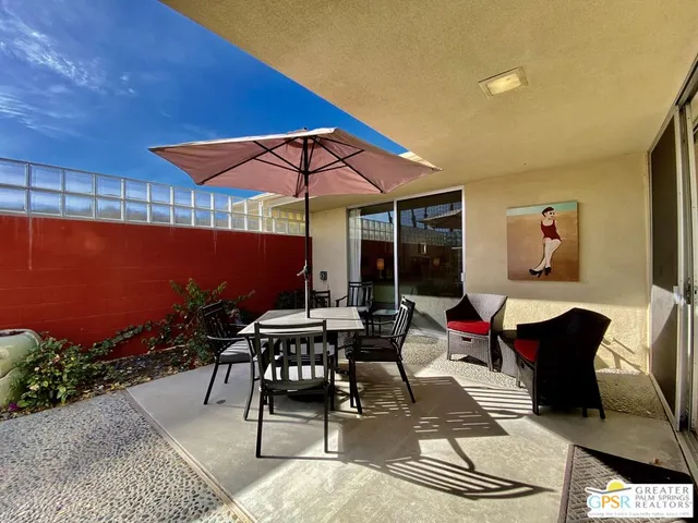 a patio with table and chairs