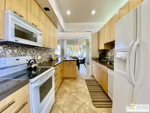 a kitchen with stainless steel appliances a stove a sink and a microwave