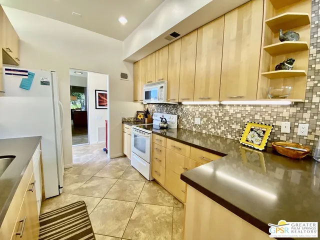 a kitchen with a sink and a stove top oven