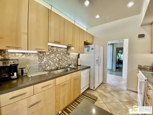 a kitchen with stainless steel appliances a counter top space and cabinets
