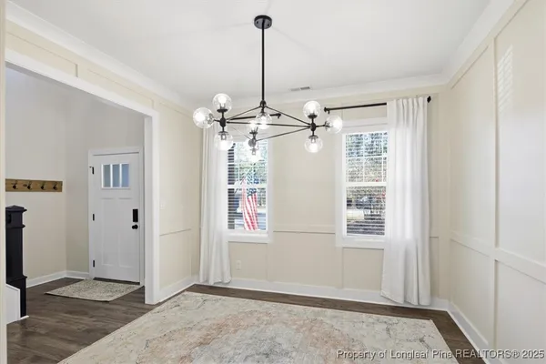 a view of a room with window and hardwood