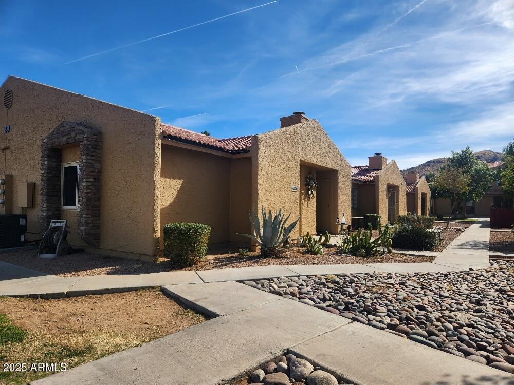 3511 East Baseline Road, Unit 1259 Phoenix, AZ 85042 - Photo 2 of 14 a front view of a house with garden