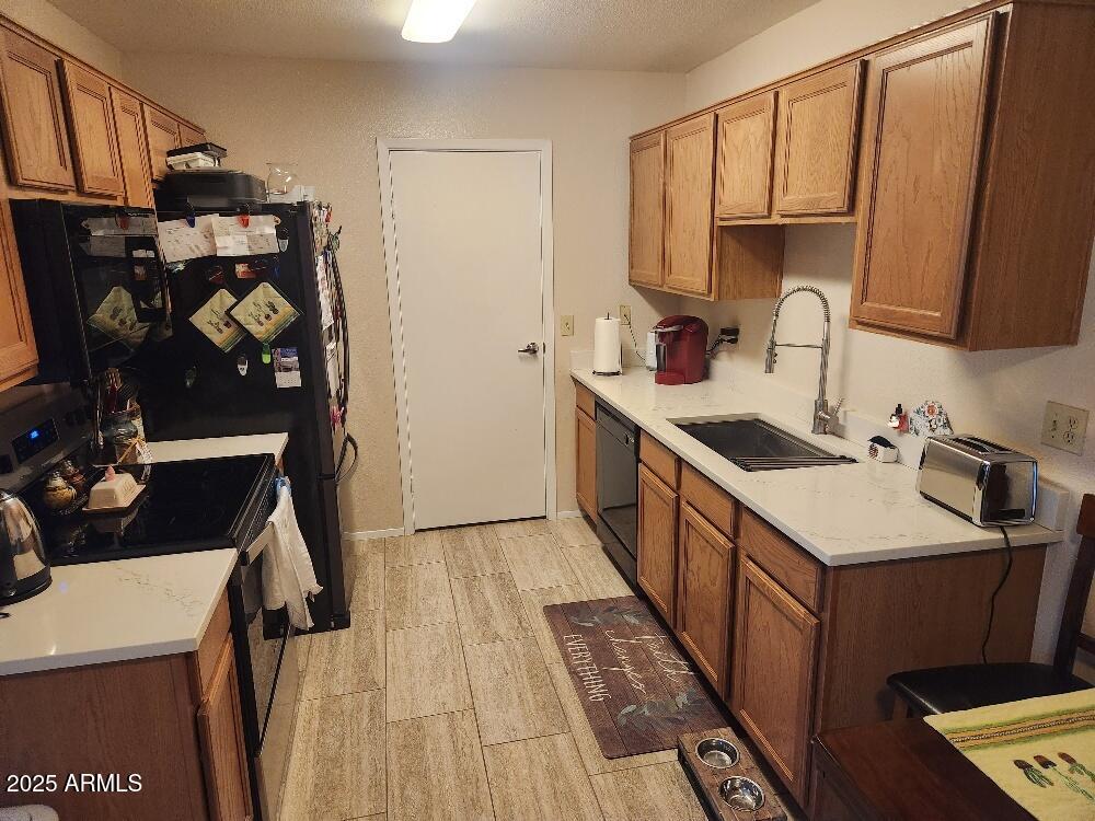 3511 East Baseline Road, Unit 1259 Phoenix, AZ 85042 - Photo 3 of 14 a kitchen with a sink a stove and cabinets