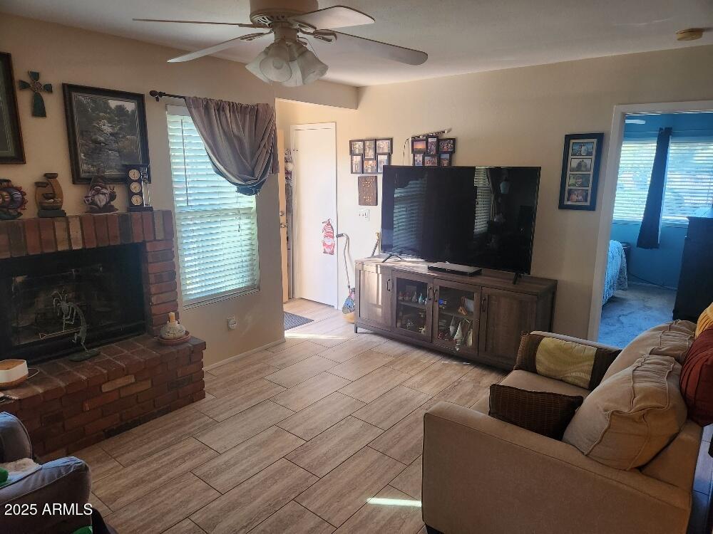 3511 East Baseline Road, Unit 1259 Phoenix, AZ 85042 - Photo 4 of 14 a living room with furniture and a flat screen tv