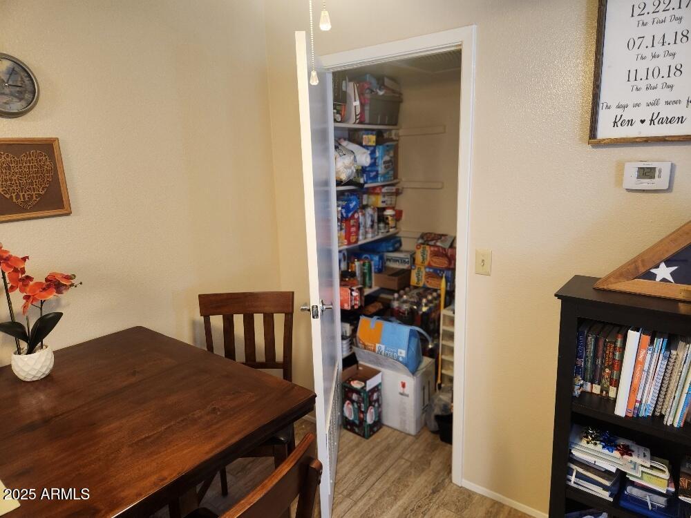3511 East Baseline Road, Unit 1259 Phoenix, AZ 85042 - Photo 8 of 14 a view of a dining room with furniture and wooden floor