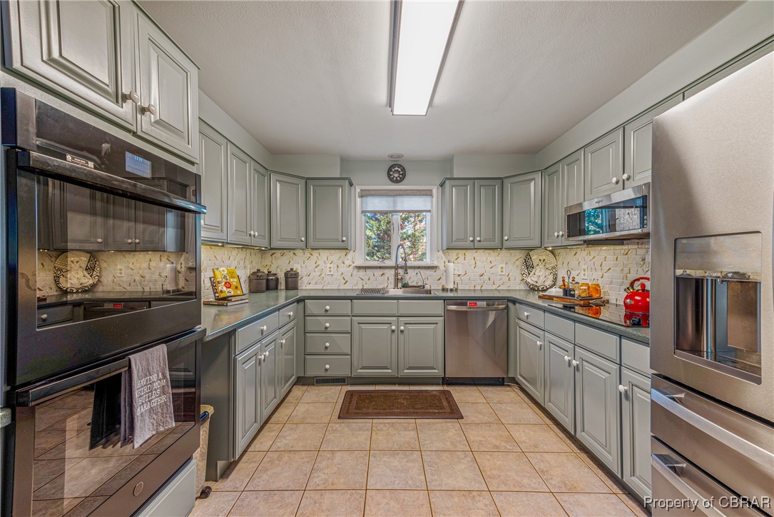 867 Holly Point Road Mathews, VA 23109 - Photo 12 of 48 Kitchen featuring appliances with stainless steel finishes, gray cabinetry, and sink